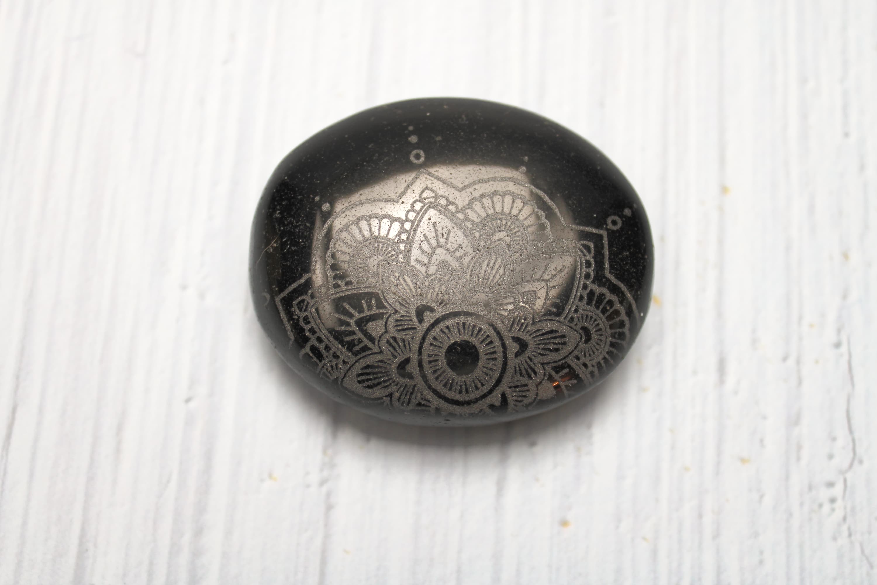Black Obsidian Mandala Etched Palm Stone - Image 1